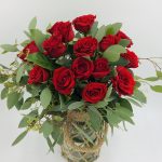 A dozen of red roses in a Jute vase