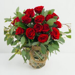 A dozen of red roses in a Jute vase